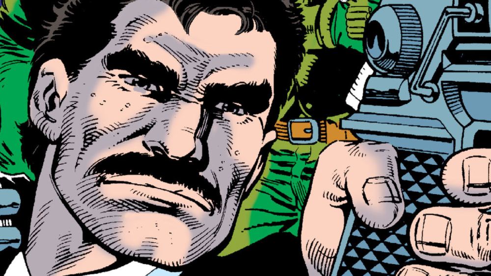 Bruno Mannheim en primer plano, bigote y chaqueta verde, mano sobre un arma, en los cómics
