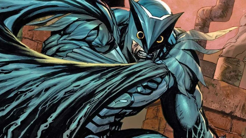 Owlman con armadura azul verdosa, máscara de búho y capa, en los cómics
